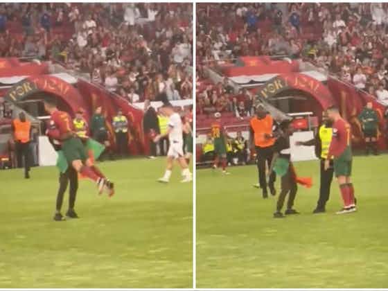 Article image:Cristiano Ronaldo picked up by pitch invader during Portugal vs Bosnia
