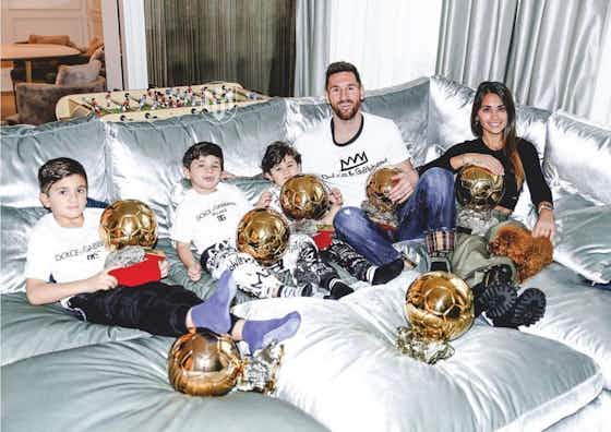 Article image:Lionel Messi and his family pose with his seven Ballon d’Or awards in Paris