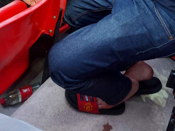 Article image:(Image) Liverpool fan spotted wearing Manchester United sliders in Anfield during match against Crystal Palace