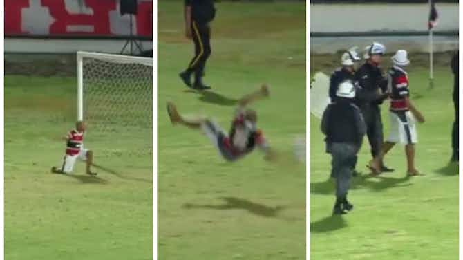 Preview image for Video: Pitch invader hilariously tries to teach goalkeeper how to dive properly